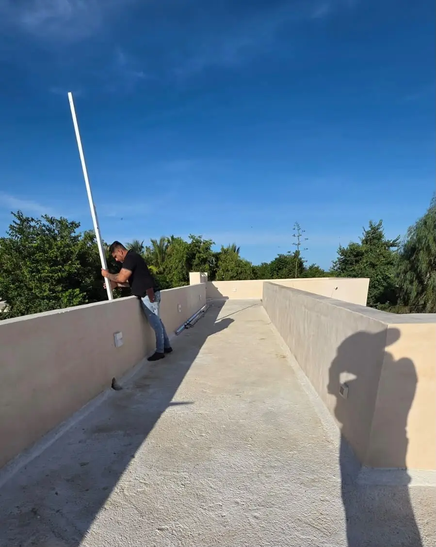 Worker coating the parapet wall