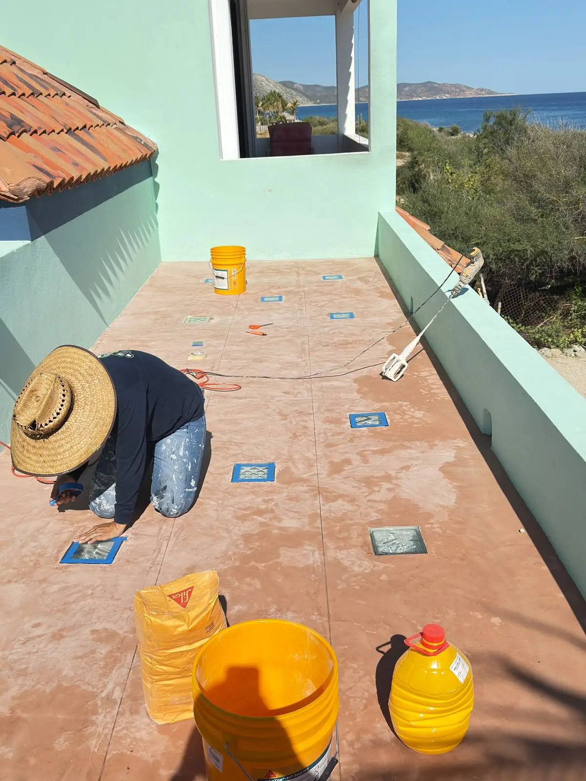 Deck before the job, with a worker prepping the surface